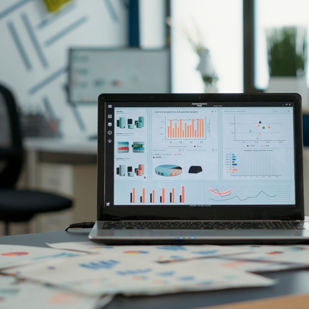 Closeup of laptop screen with enterprise resource planning showing moving charts and growing