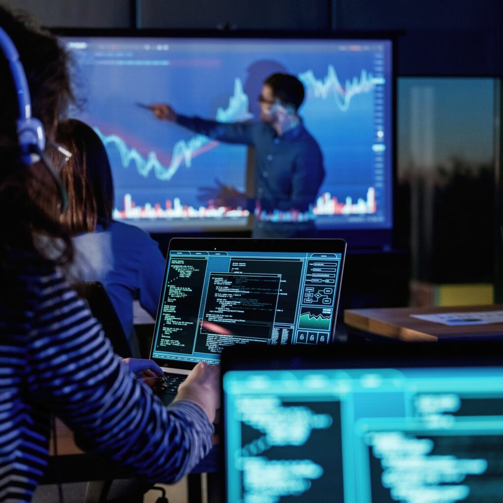 Male business trainer is against projector with data, teaching people