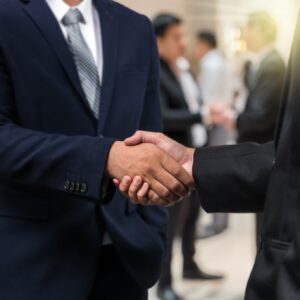 Business shaking hands of partner over the photo blurred of group of Businessman Corporate