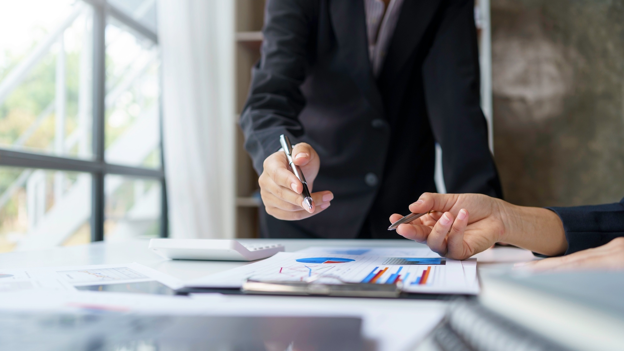 Business people analyzes, graphs and charts to examine and analyze company finances, revenues