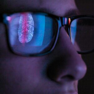 Cyber Security, reflection in spectacles of access information being scanned on computer screen