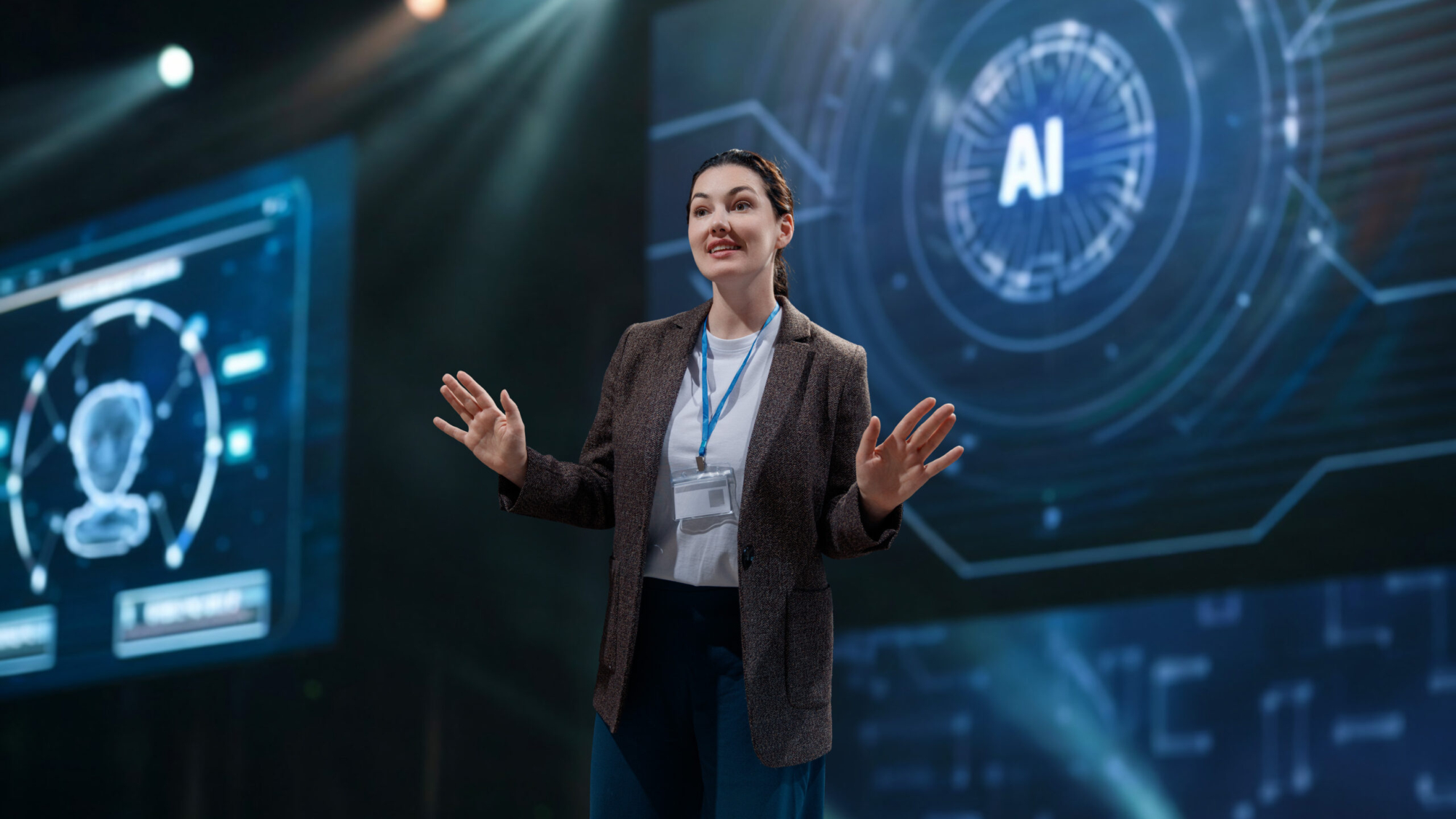 A woman is speaking on stage about the future of AI technologies.