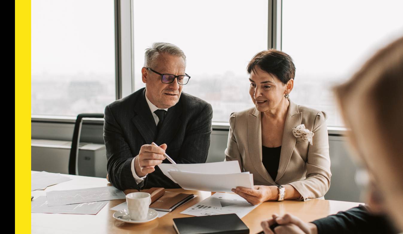Two EY Microsoft consultants discussing a project while seated