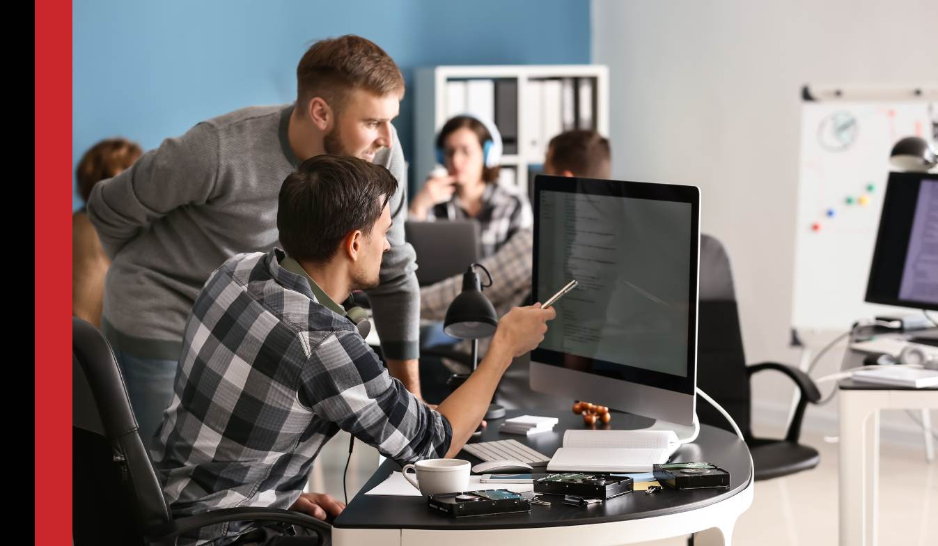 Two Microsoft consultants from Strategix working at a desktop computer