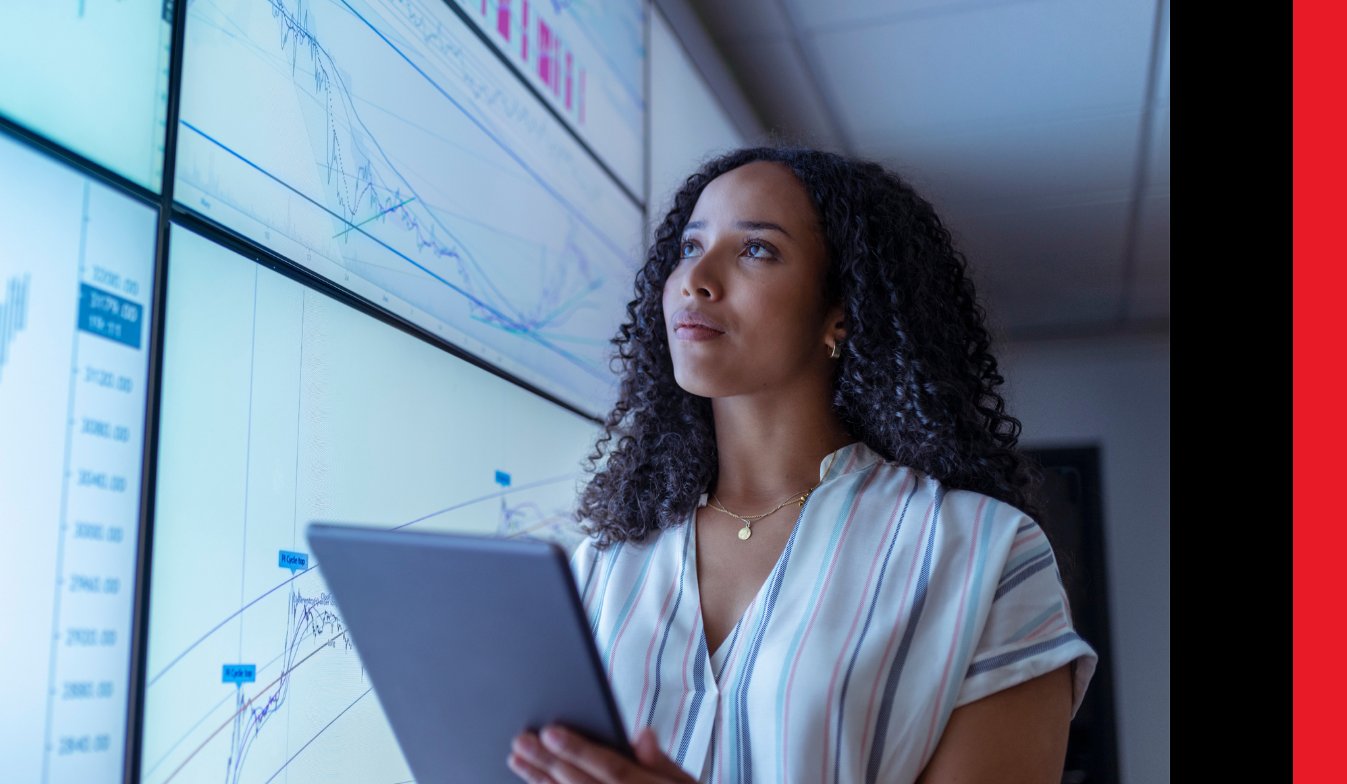A BCX analyst taking a look at data across a large screen