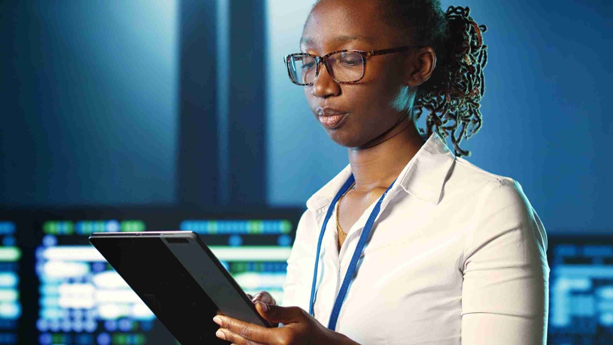 A data analyst looking at her tablet