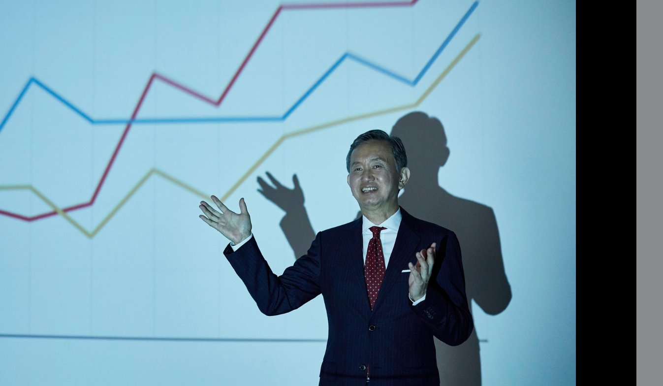 A PBT Group analyst conducting a presentation in an auditorium