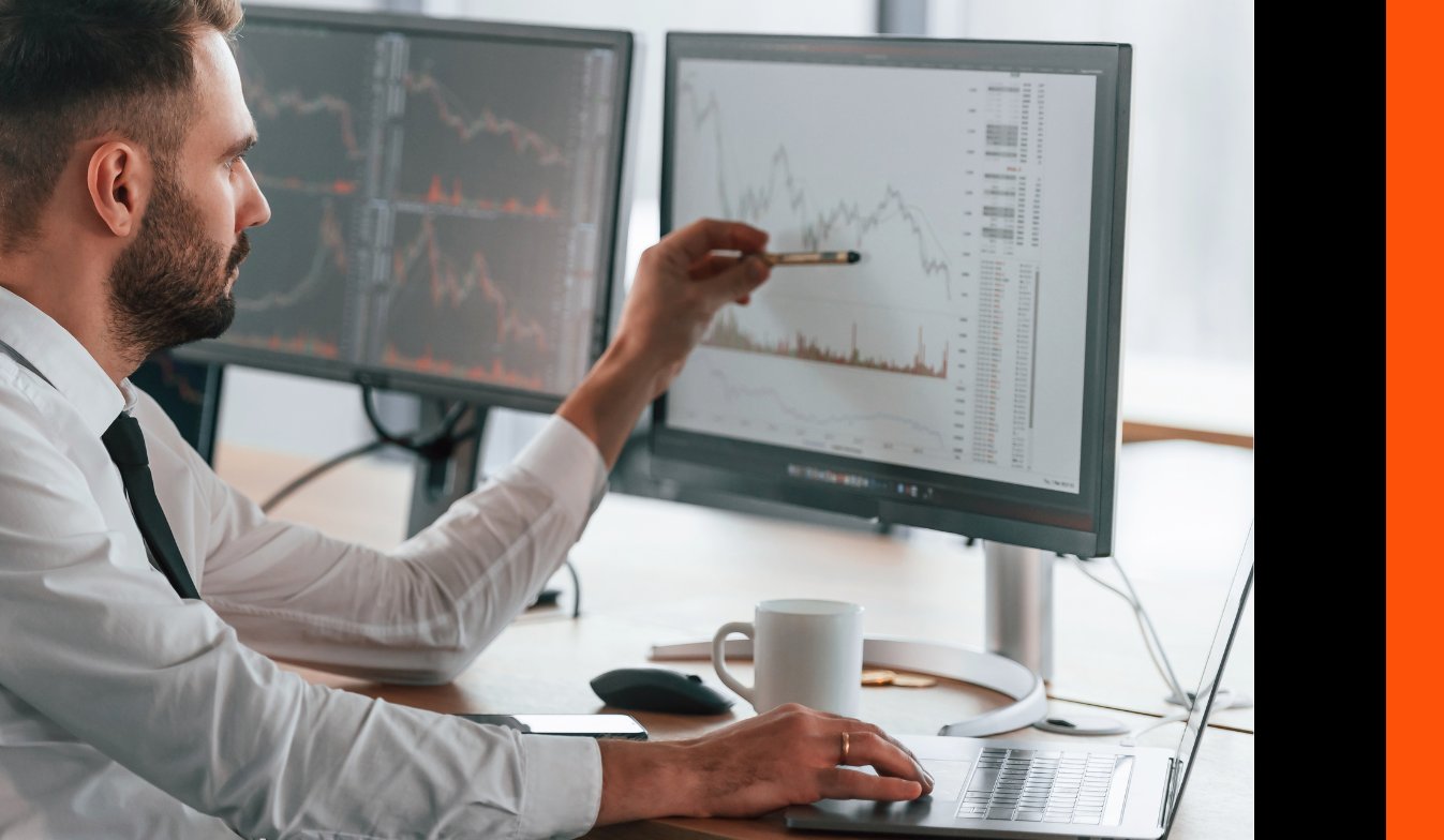A PWC data analyst analysing a problem on a desktop computer