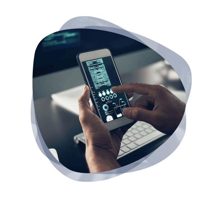 A Microsoft developer from Mint holding a white phone, which is displaying a feature page of a new prototype.