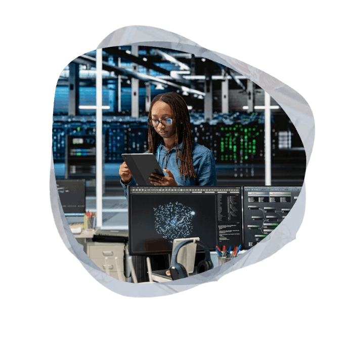 A technical professional using a tablet in a data center to manage enterprise-grade Agentic AI Development Services.