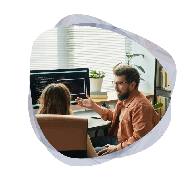 Two developers reviewing code and workflows for custom Microsoft AI Solutions.