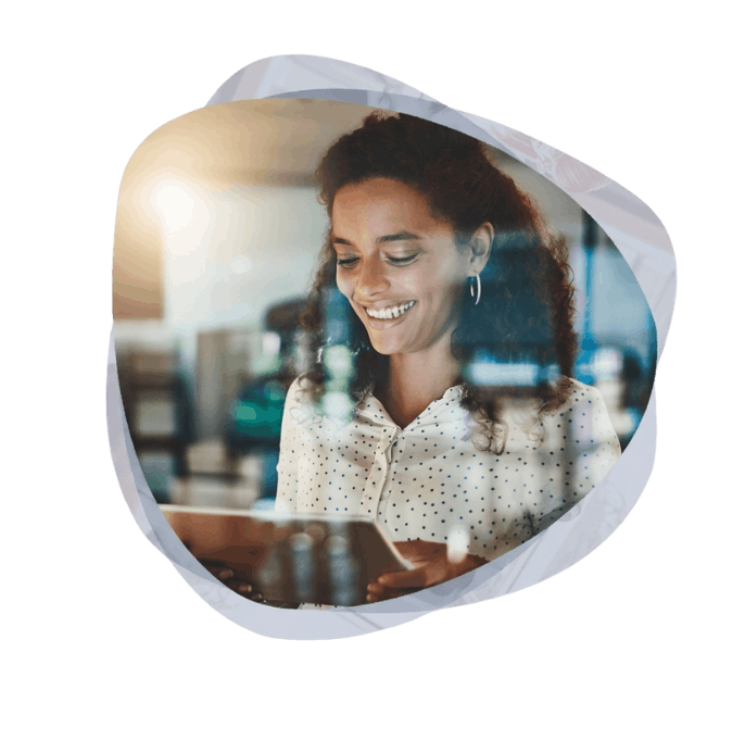 A smiling professional using a tablet to streamline daily tasks through Microsoft Business Process Automation Services.