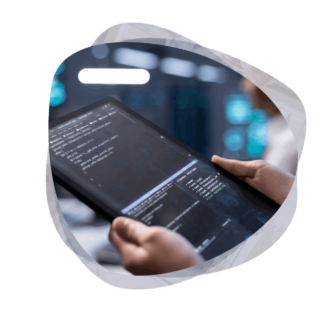 A developer's hands holding a tablet with code, representing the development of custom Power Platform applications and enterprise application solutions.