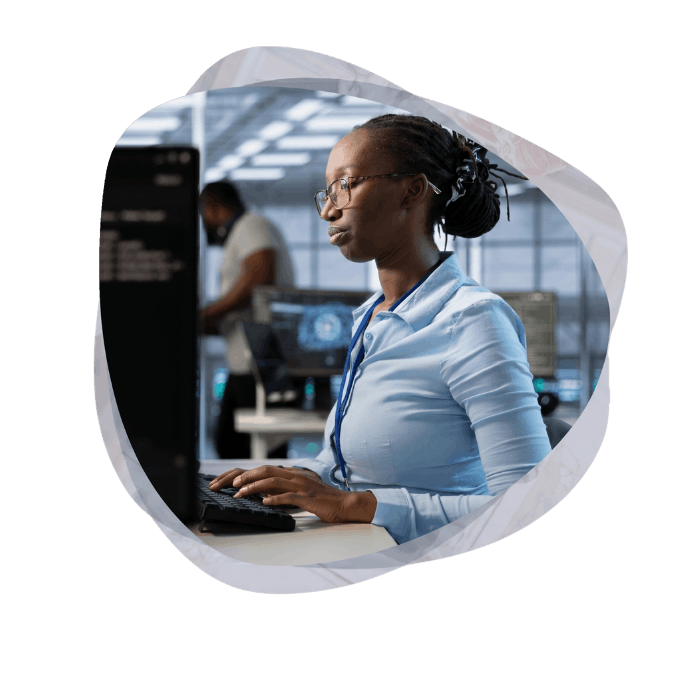 A female IT professional designing employee portals and intranets at her workstation, showcasing custom enterprise application software development.