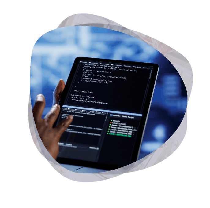 A close-up view of a person using a tablet to review code during the custom Power Platform application development process.