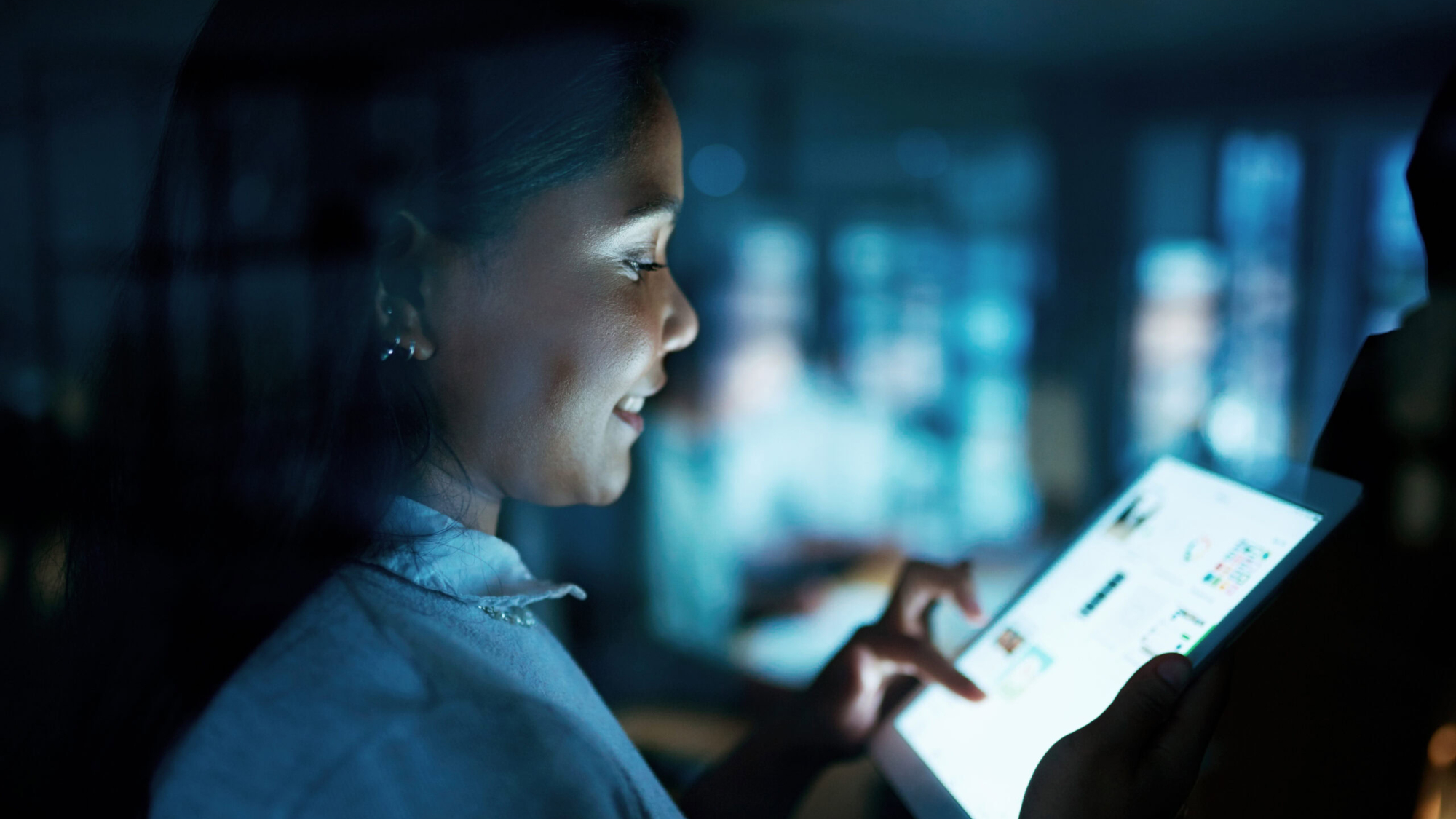 Shot of a young businesswoman using a digital tablet during a late night at work.
