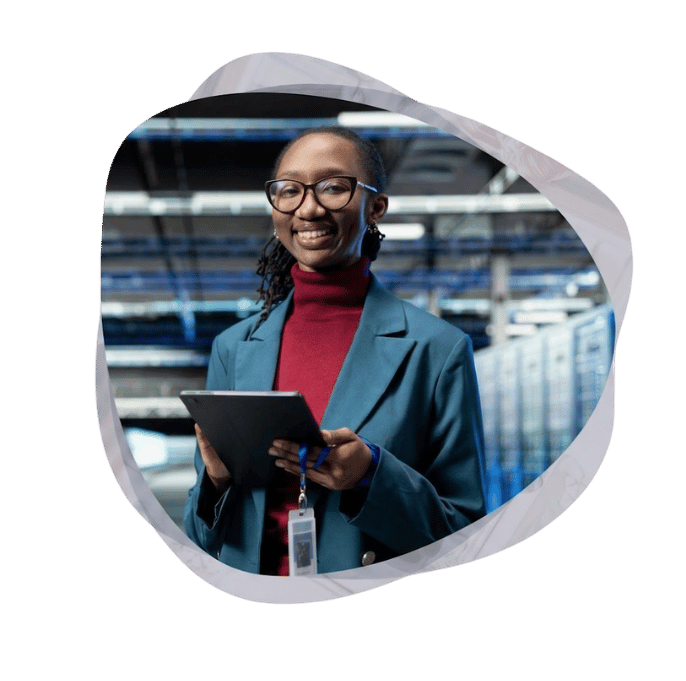 IT professional holding a tablet in a data centre during a Microsoft 365 application migration.